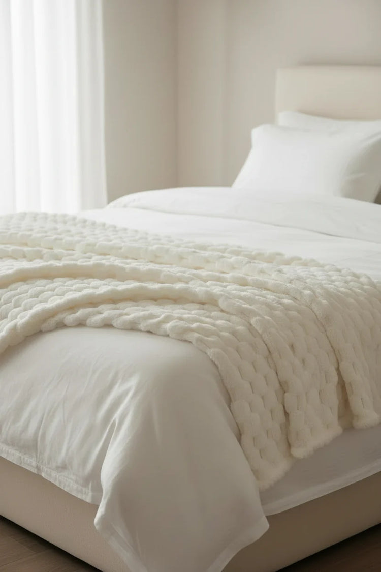White knitted blanket on a white background