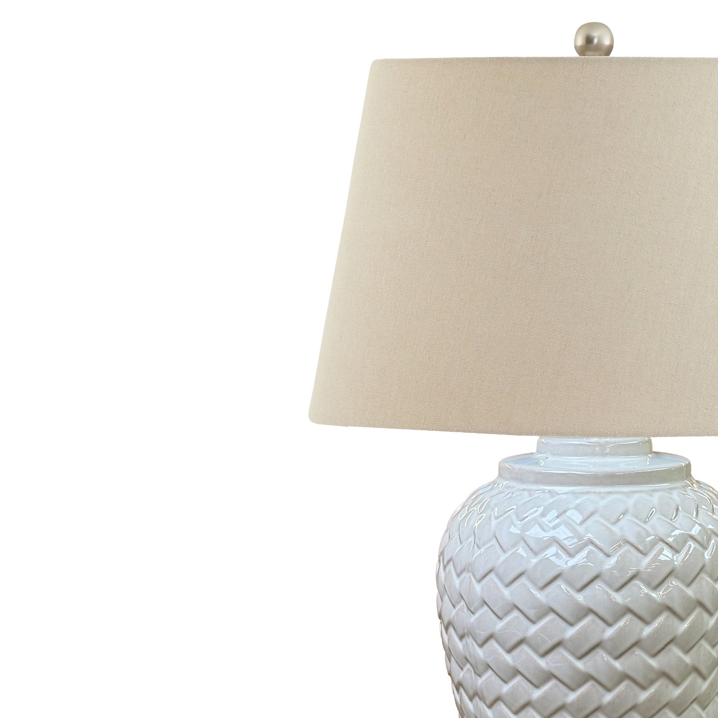 Table lamp with woven design base and beige lampshade on a white background