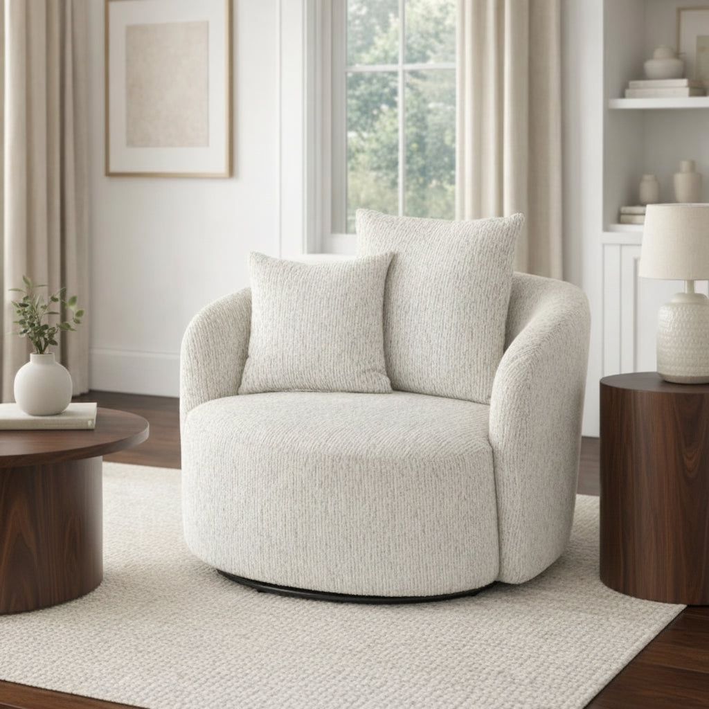 Beige armchair in a living room setting with a wooden coffee table and lamp.