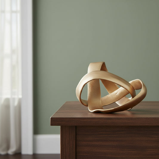 Gold abstract sculpture on a white background