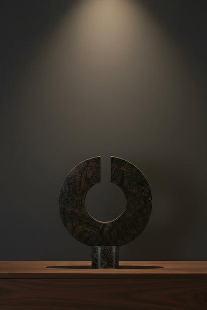 Decorative stone sculpture with a circular design on a white background