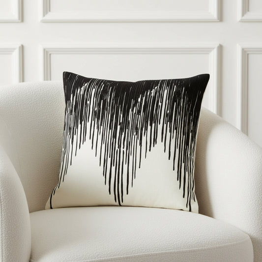 Decorative pillow with black fringe on a white background