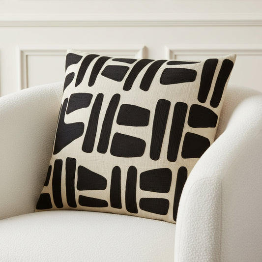 Decorative pillow with black abstract pattern on beige background