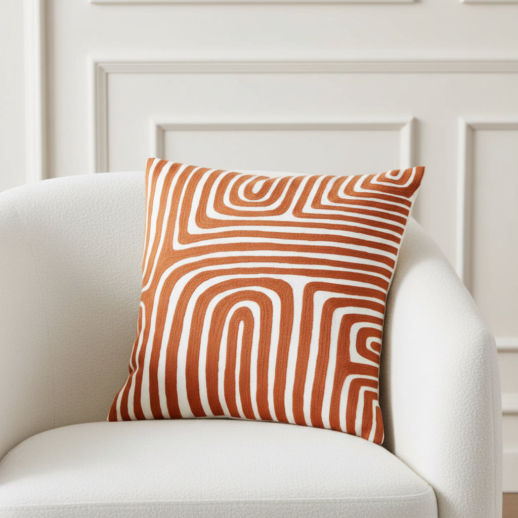 Decorative pillow with brown and white wavy pattern on a white background