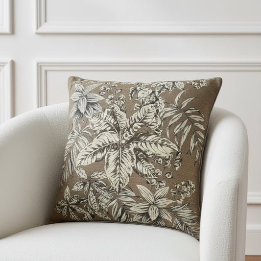 Decorative pillow with leaf pattern on a brown background