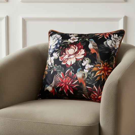 Decorative pillow with floral and bird pattern on a black background