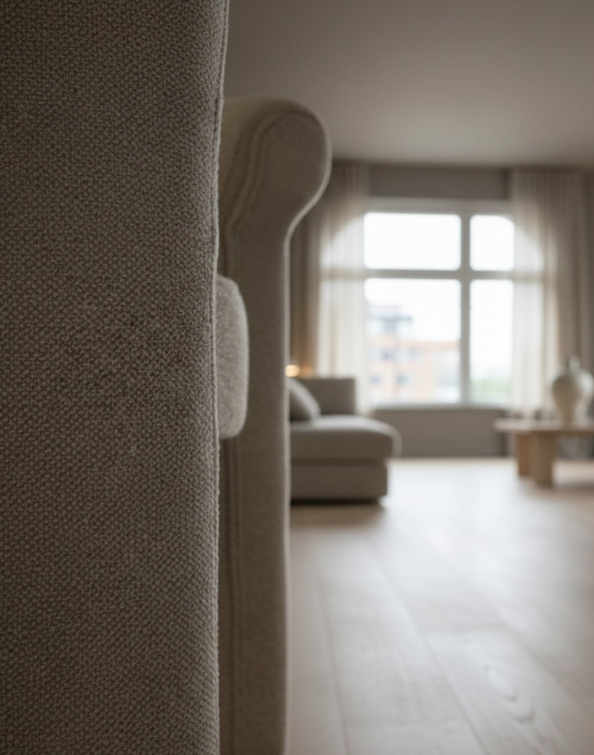 Close-up of a textured gray sofa with a blurred background