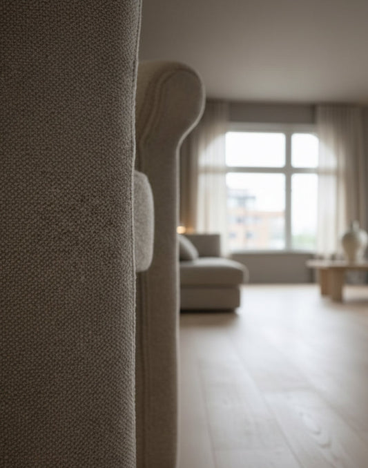 Close-up of a textured gray sofa with a blurred background